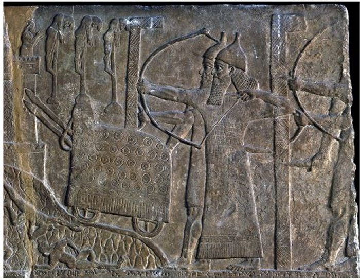 Siege Scene With Two Mᴀssive L-Shaped Shields Protecting ᴀssyrian Soldiers, In A Relief From The Palace Of Tiglath-Pileser III At Nimrud (Courtesy Of The British Museum