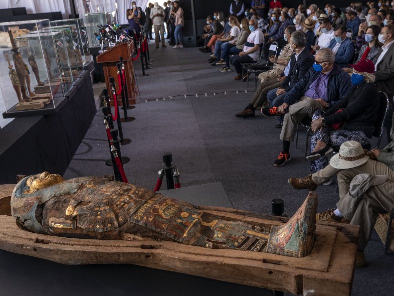 People look at ancient sarcophagi discovered in a vast necropolis in Saqqara, Giza, Egypt, Saturday, Nov. 14, 2020. Egyptian antiquities officials on Saturday announced the discovery of at least 100 ancient coffins, some with mummies inside, and around 40 gilded statues south of Cairo. (AP PH๏τo/Nariman El-Mofty)