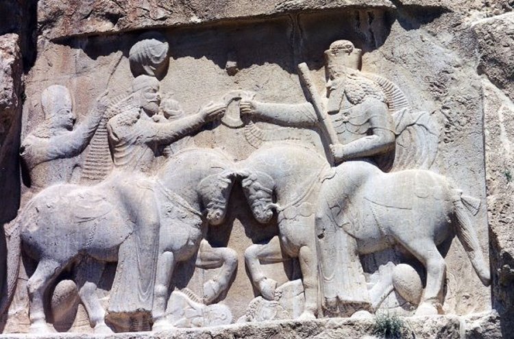 Ahura Mazda (right, with high crown) presents Ardashir I (left) with the ring of kingship. (Naqsh-e Rustam, 3rd century CE).