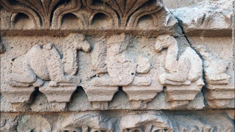 Artwork on a temple in northern Iraq depicts hybrid camels flanking a royal figure.