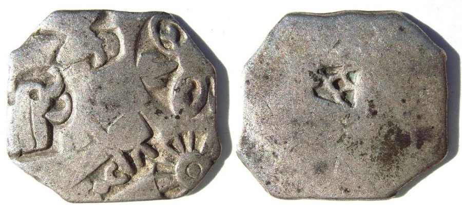 Silver coin of the Maurya Empire, known as rūpyarūpa, with symbols of wheel and elephant. 3rd century BC.