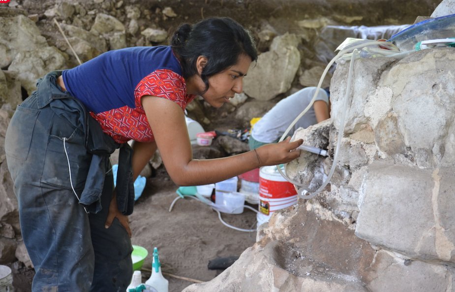 INAH archeologists working with a stucco relic.