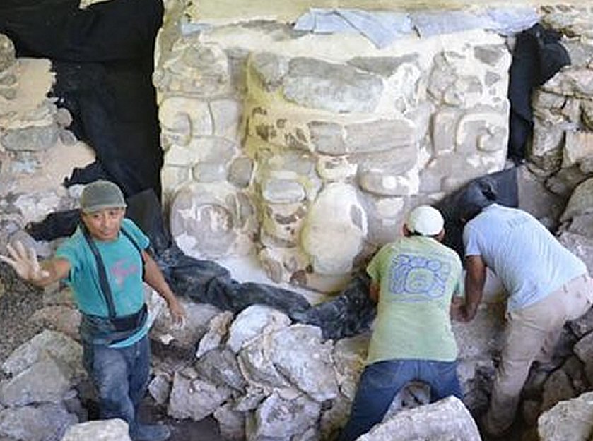 INAH archeologists working with a stucco relic.