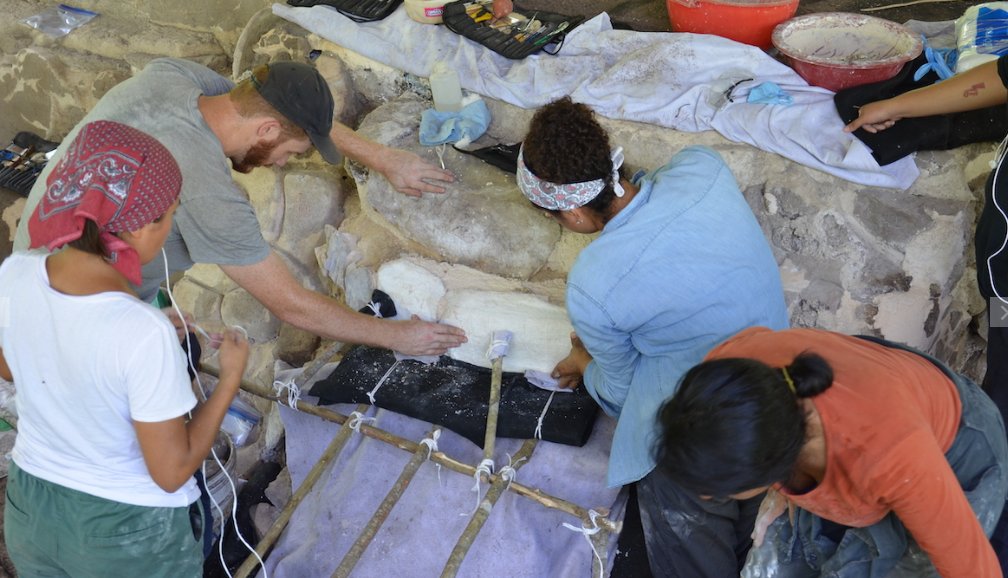 Ucanha site - archaologists work with a stucco mask.