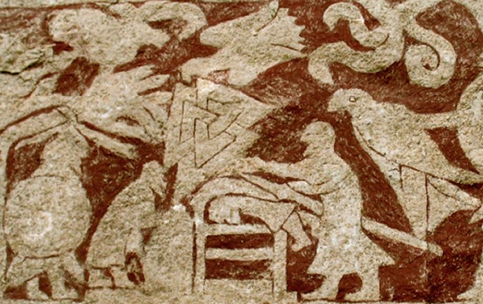 Stone fragment from Stora Hammar I, Gotland. A valknut stands prominently in the center, next to a character analyzed as the god Odin , with his characteristic spear . He pushes another figure into a burial mound, while a crow hangs above his head and another man is hanged.